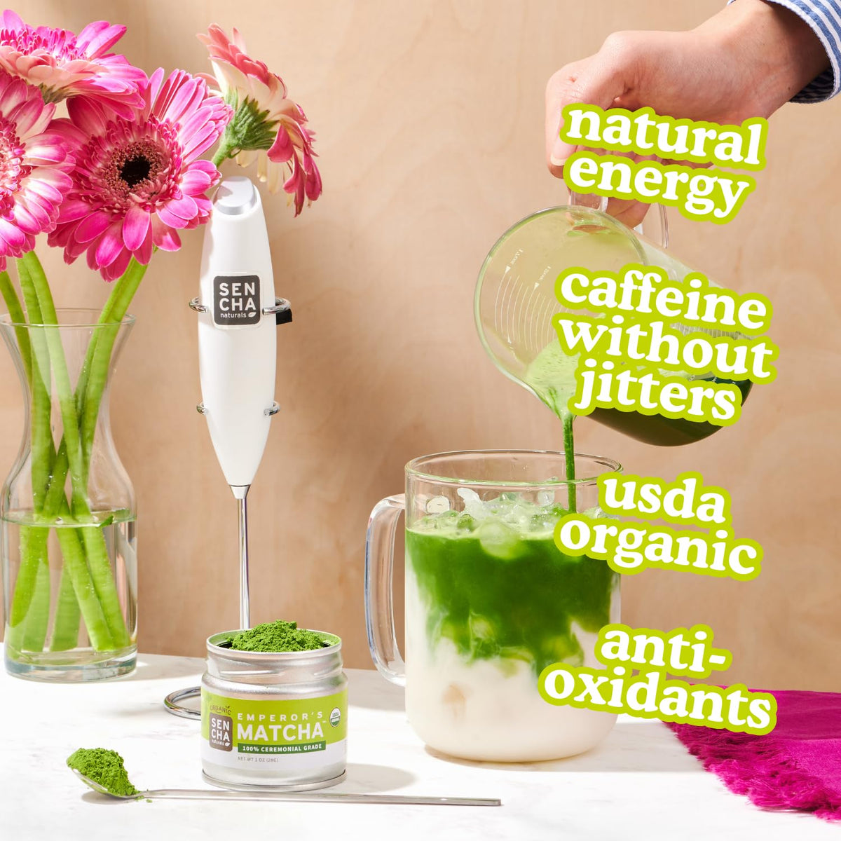 Scoop of matcha powder beside a prepared cup