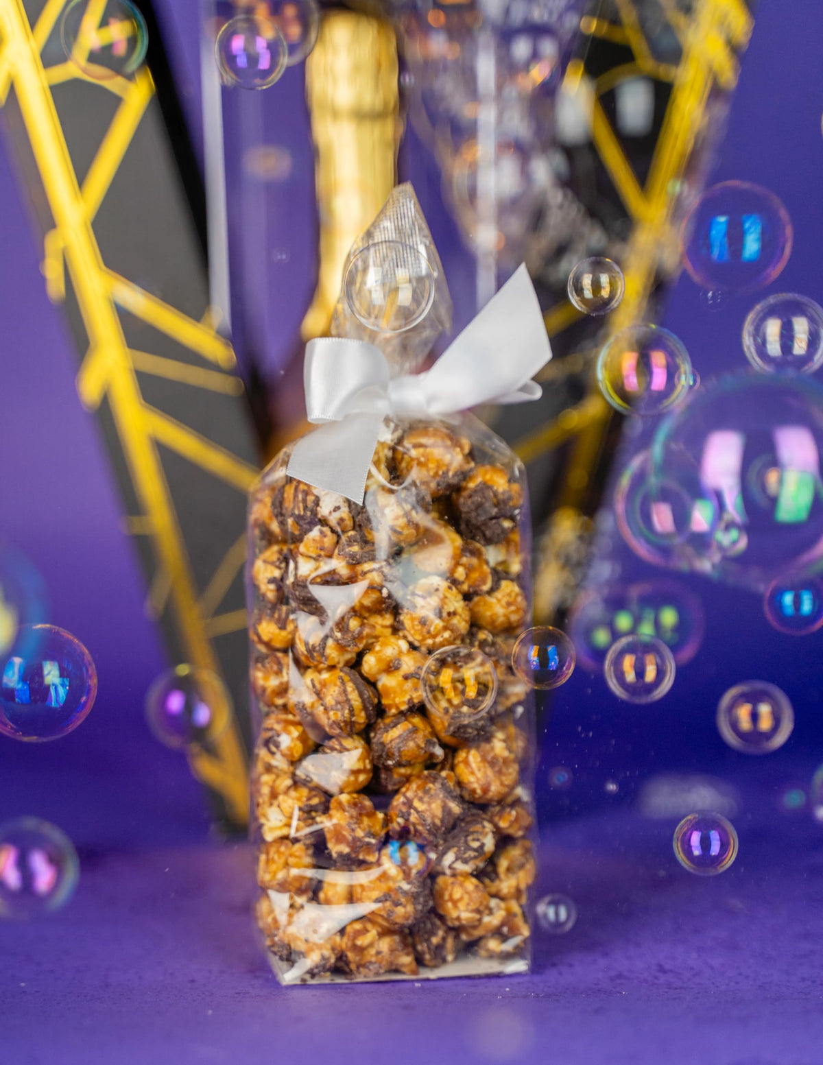Send A Cake unboxing moment capturing popping bubbles experience.