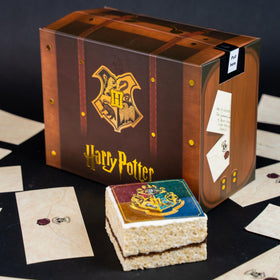 Send A Cake Hogwarts crest crispy treat—soft cake with edible crest.