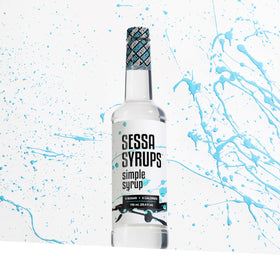 Close-up of Sessa Syrups label highlighting natural flavors and sugar-free formula.