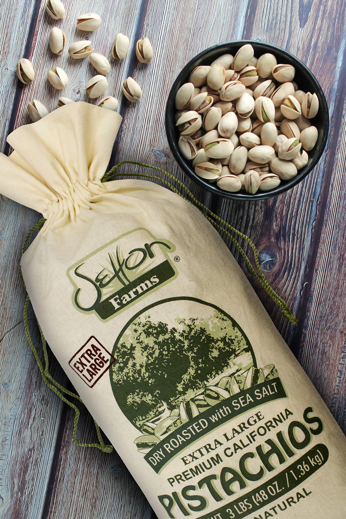 Setton Farms pistachios cracked open, showing green kernels for a protein-rich snack.