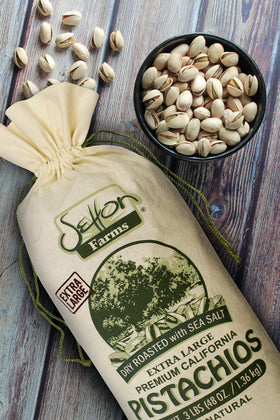 Setton Farms pistachios cracked open, showing green kernels for a protein-rich snack.