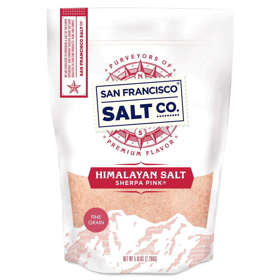 Sherpa Pink Himalayan salt bottle close-up shows fine grain ideal for precise seasoning.