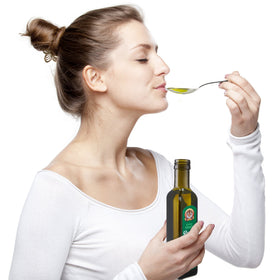 Siberian Tiger Naturals oil drips from a wooden spoon