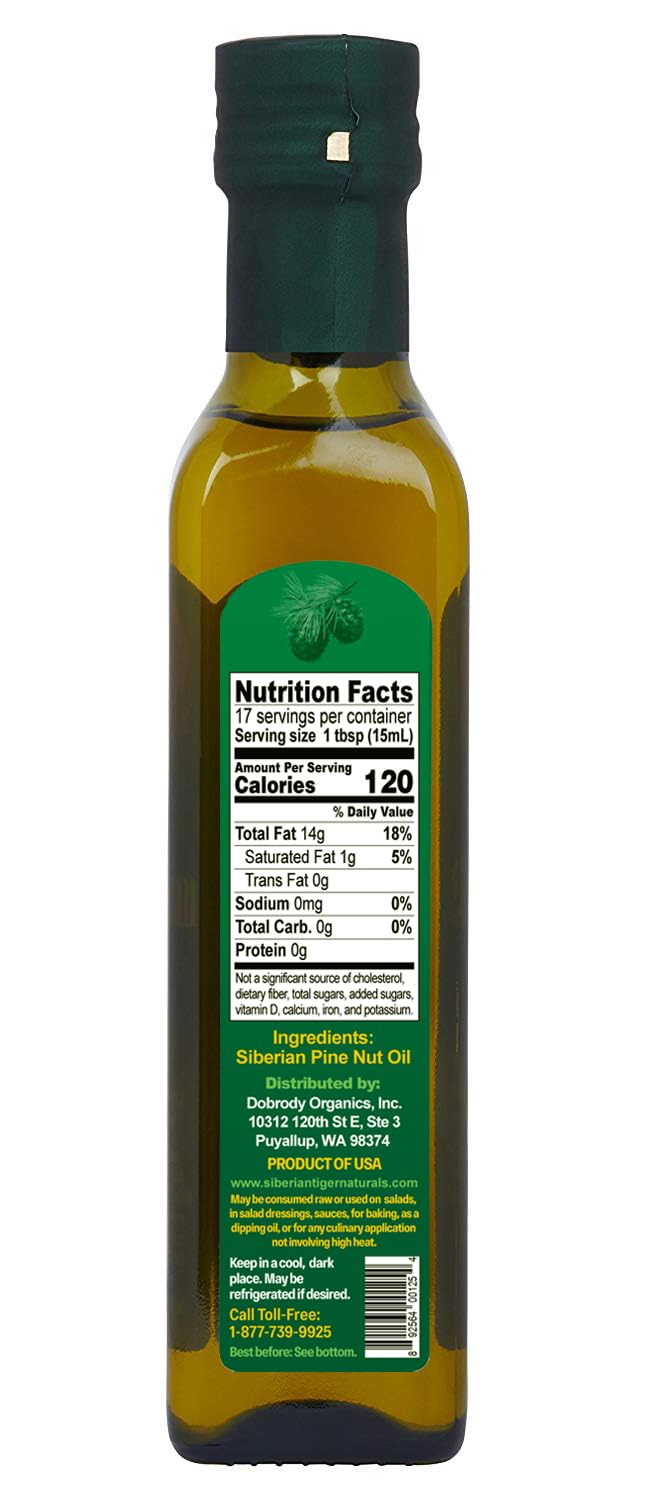 Siberian Tiger Naturals pine nut oil being poured over a salad
