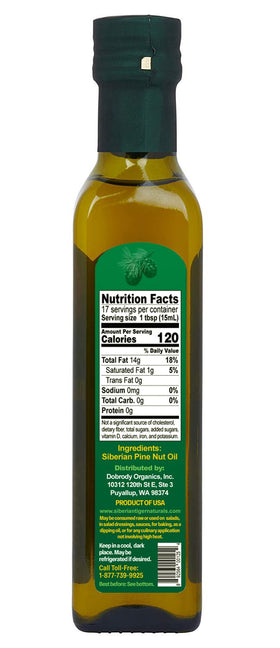 Siberian Tiger Naturals pine nut oil being poured over a salad
