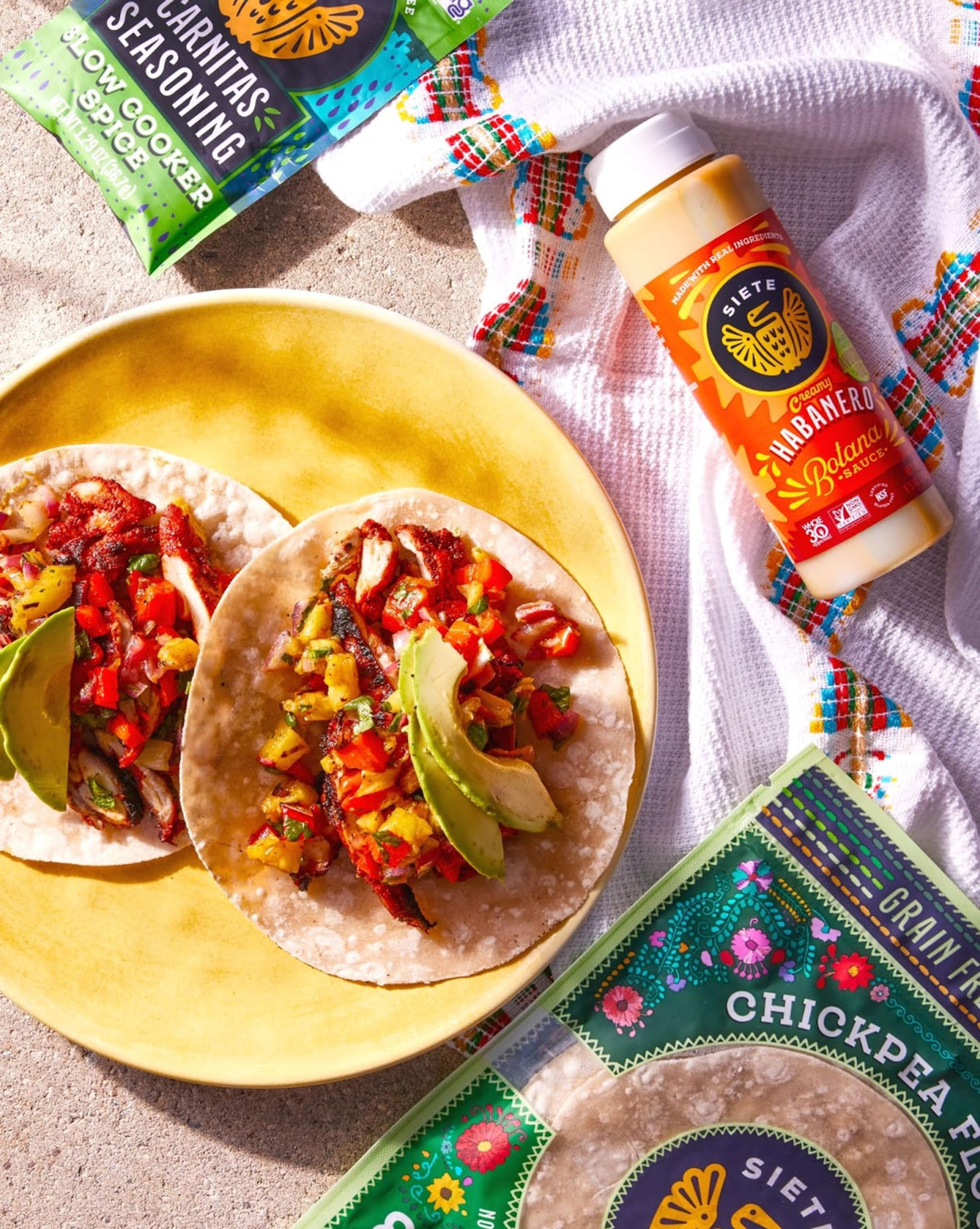 Jar close-up of Siete Carnitas seasoning highlighting gluten-free and paleo-friendly ingredients.