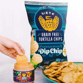 Siete chips beside salsa for dipping at a family gathering