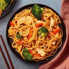 Stir-frying Simply Asia Lo Mein noodles with vegetables.