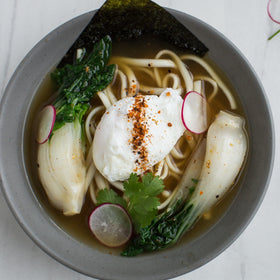 Simply Asia ramen seasoning glass bottle close-up—versatile for noodles, soups, and veggies.