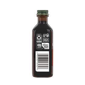 Pouring Simply Organic Madagascar vanilla extract into a mug for a warm drink