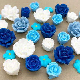 Edible blue and white floral decorations from Simply Sucré enhance dessert presentation