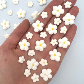 Simply Sucré Royal Icing Blossoms adorn a wedding cake for edible elegance