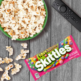Skittles Sours Wild Berry pack on a snack tray with movie-night vibe.