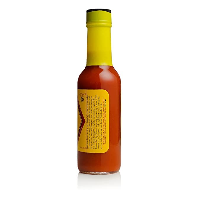 Slap Ya Mama Louisiana hot sauce label closeup highlights Cajun spice blend.