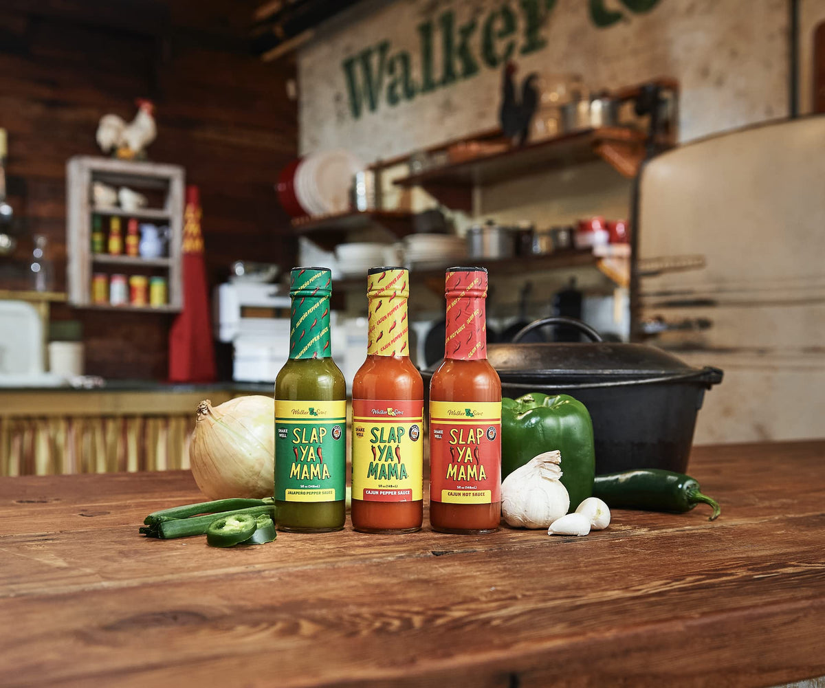 SLAP YA MAMA table setup featuring spice can and hot sauce