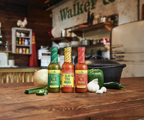 SLAP YA MAMA table setup featuring spice can and hot sauce