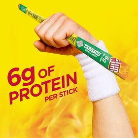 Hand holding Slim Jim Giant Tabasco smoked meat stick showing portion size.