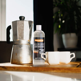 Smart for Life allulose syrup being poured into coffee for keto-friendly sweetness