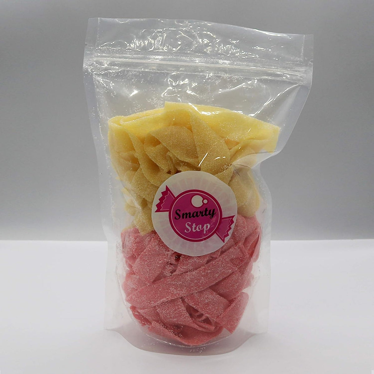 Smarty Stop Sour Every Flavor Mixed Gummy Belts pink lemonade close-up, refreshing party treat.