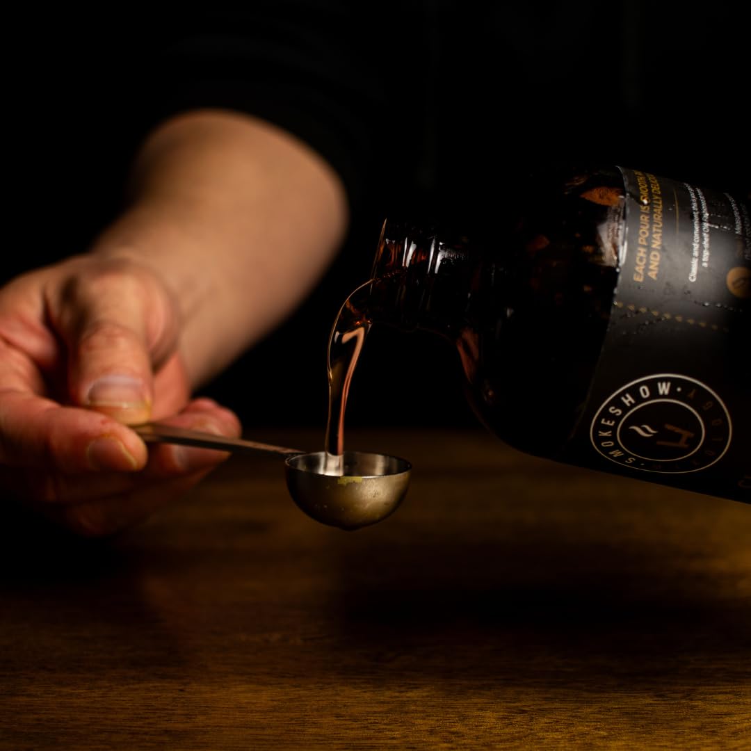 Smokeshow syrup with citrus peel garnish on a bar