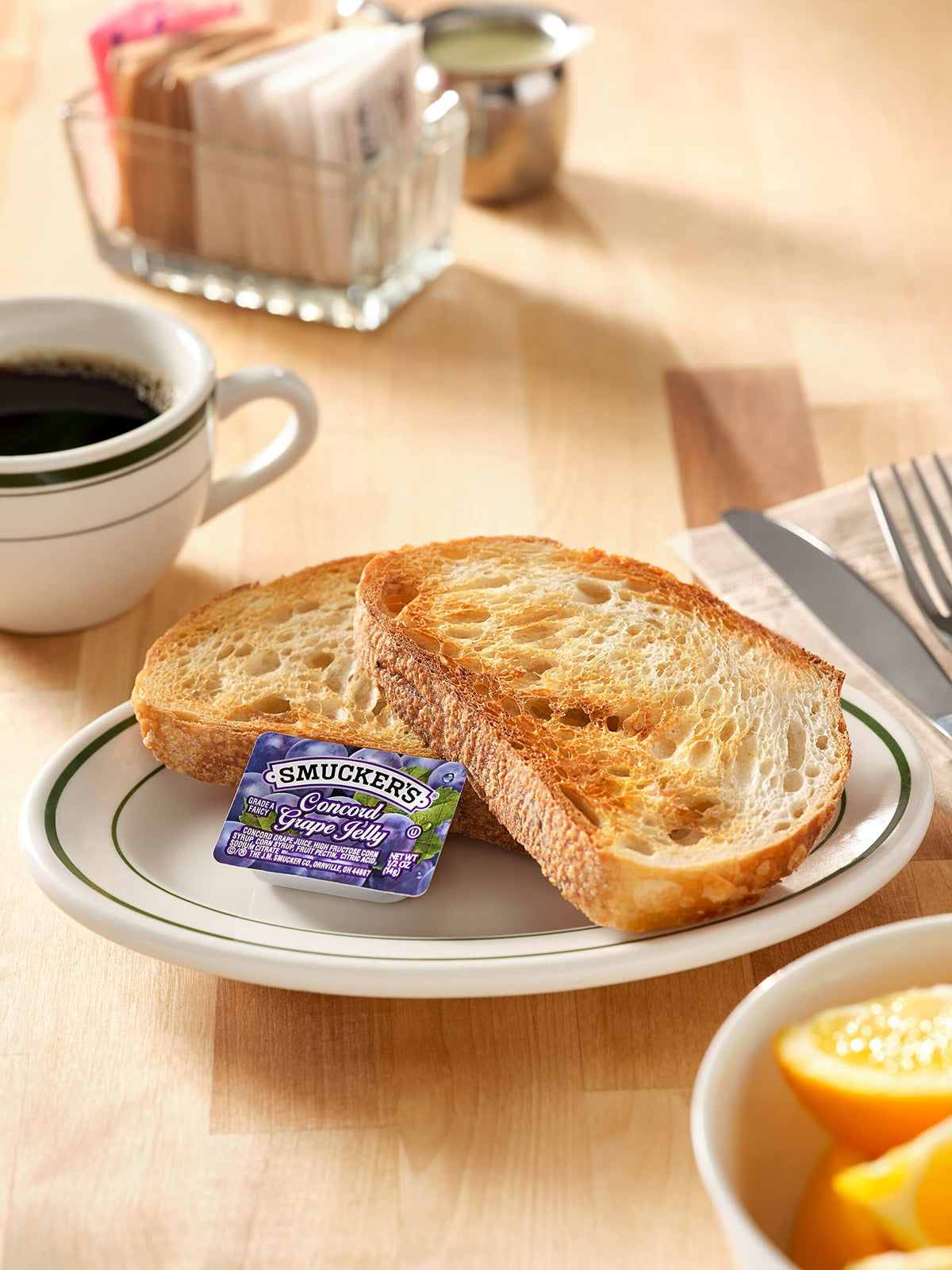 Smucker's Concord Grape Jelly cup lid with traceability code for safe distribution.