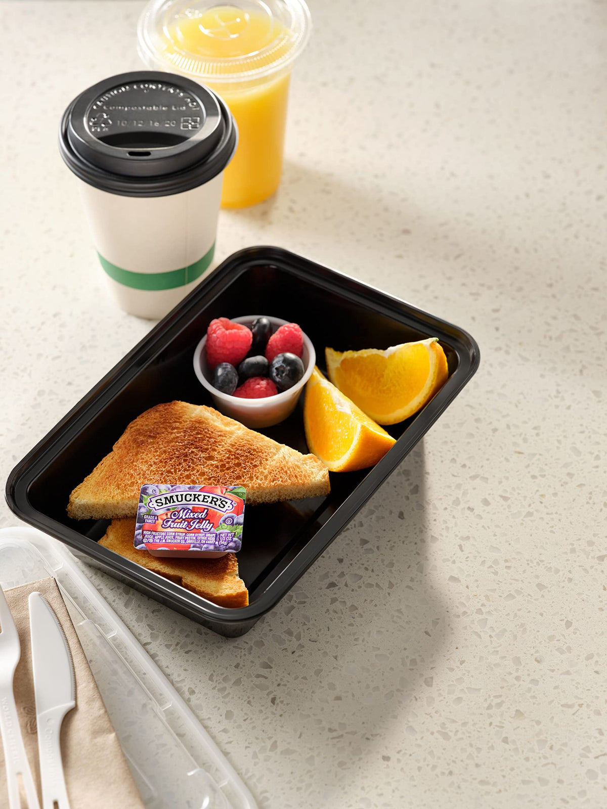 Smucker's Mixed Fruit Jelly portion-control cups for easy, mess-free service in cafeterias.