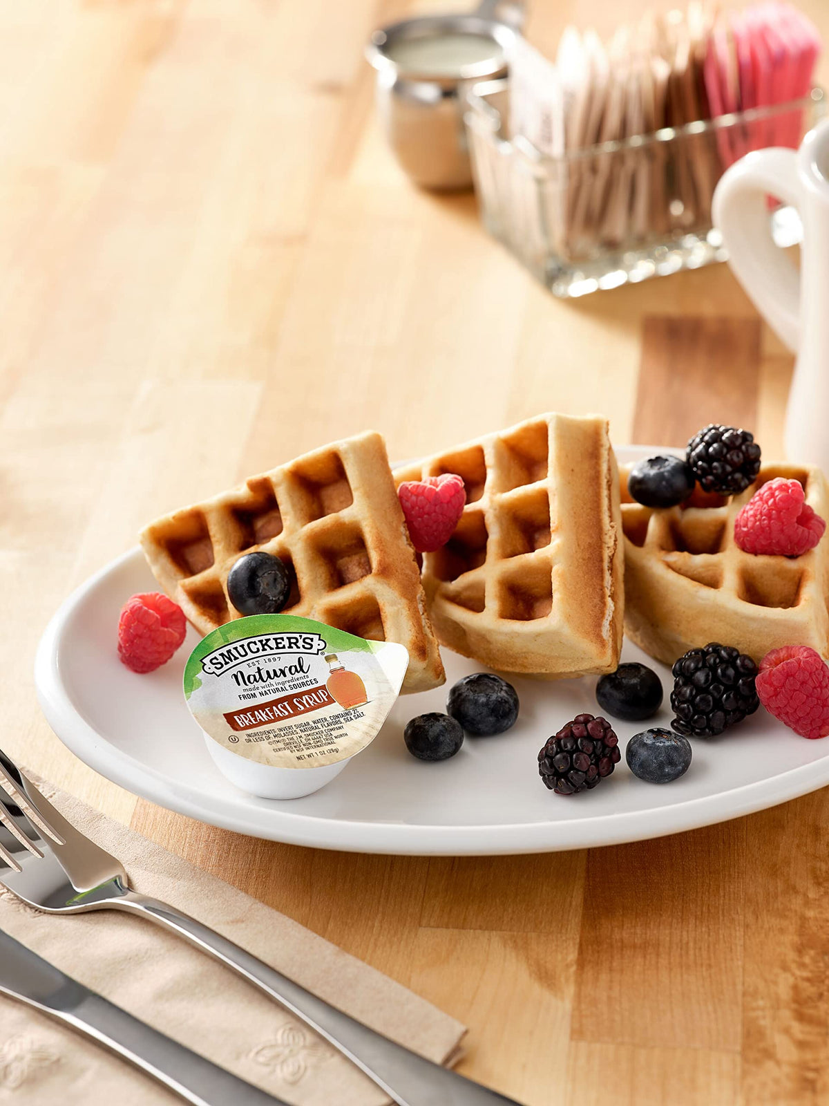 Pour-ready Smucker's Natural Syrup 1oz cup for quick, mess-free servings.