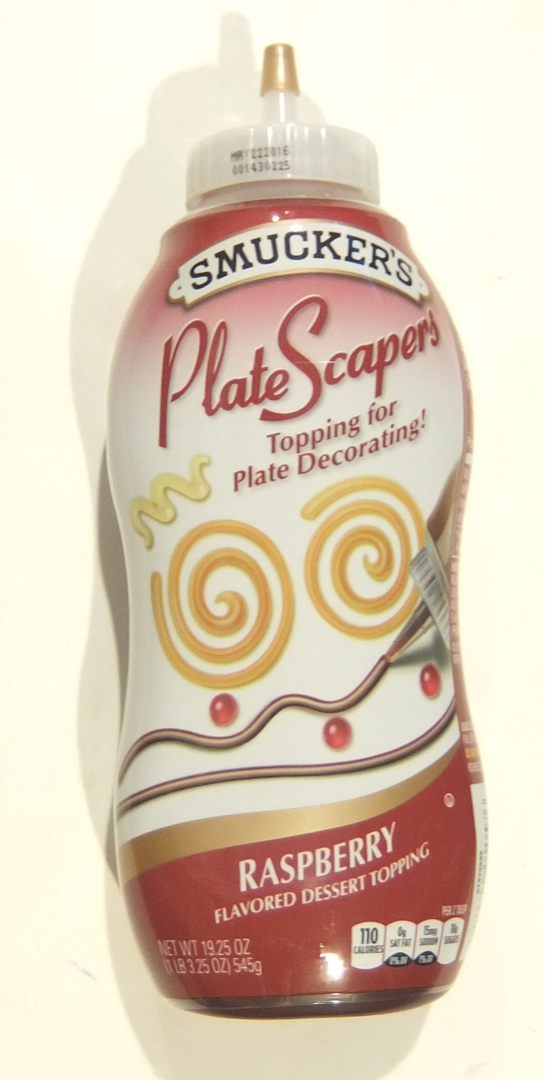 Smucker's PlateScapers raspberry topping bottle pour for precise, elegant plate decorations.