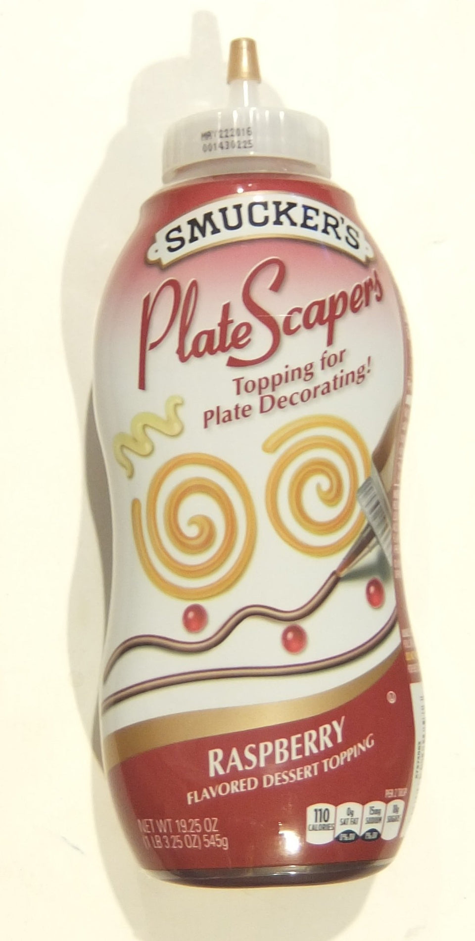 Smucker's PlateScapers raspberry topping bottle pour for precise, elegant plate decorations.