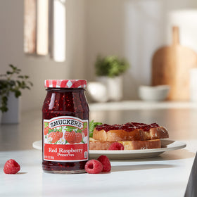 Smucker's 6-pack jars shown with savory glaze base idea on cheese board.