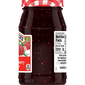 Smucker's Red Raspberry Preserves on toast beside cheese, inviting gourmet pairing.
