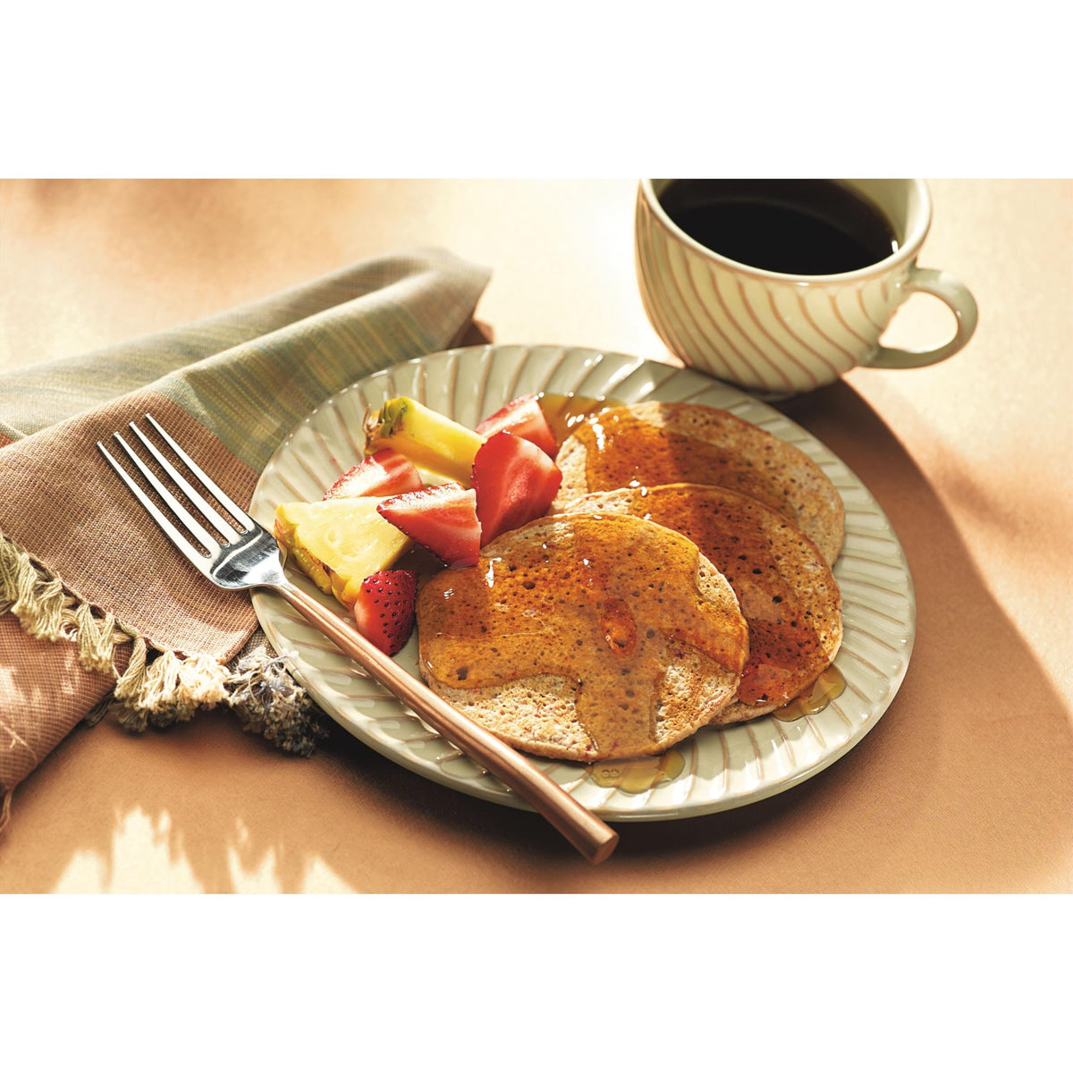 Smucker's Sugar Free Breakfast Syrup serving on a plate with a cozy setting.