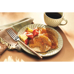 Smucker's Sugar Free Breakfast Syrup serving on a plate with a cozy setting.