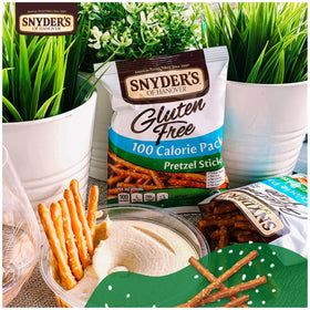 Snyder's Gluten Free Pretzel Sticks dip idea image demonstrates pairing options with hummus or cheese.