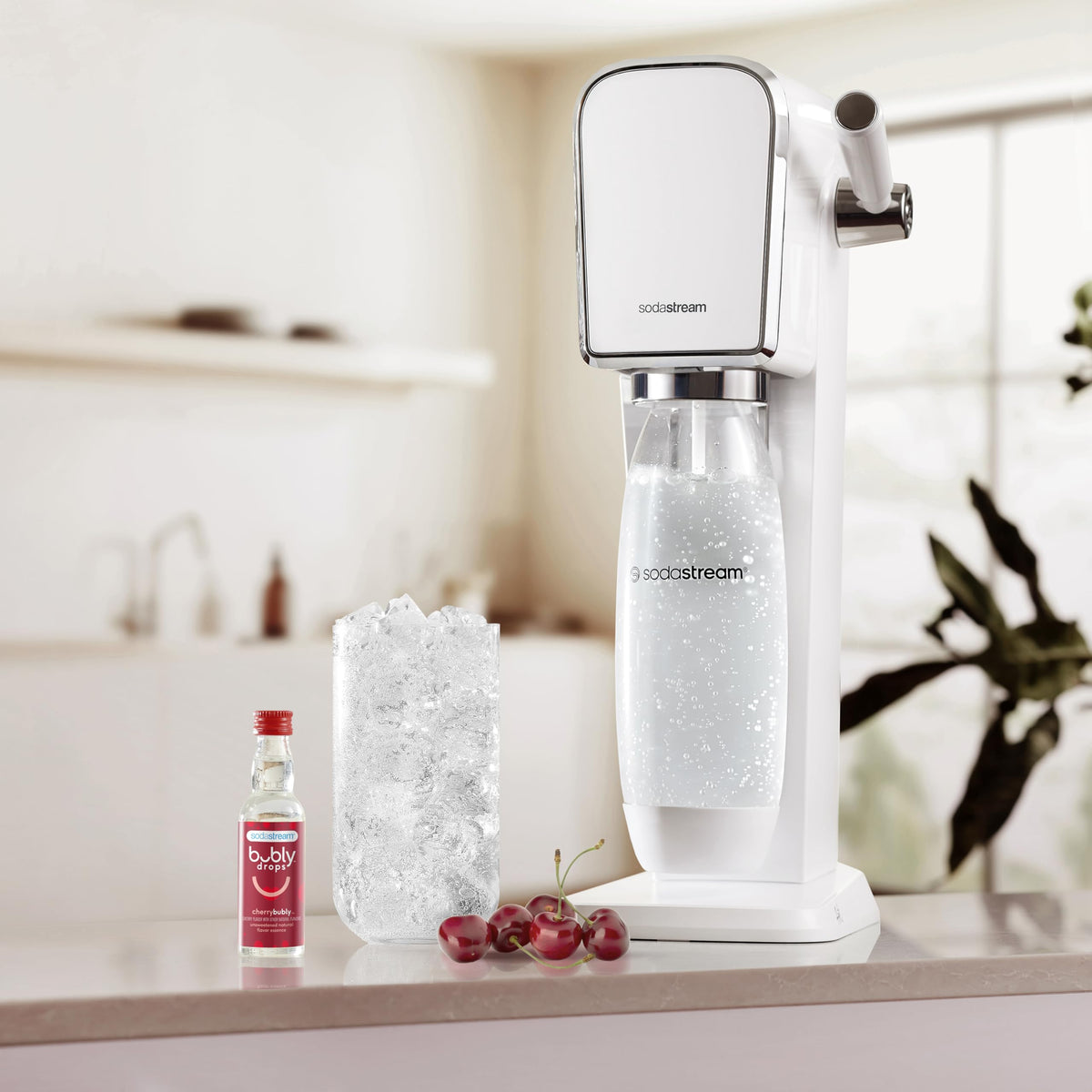 Glass of Sodastream bubly Drops Cherry sparkling water with bright bubbles.