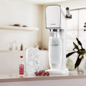 Glass of Sodastream bubly Drops Cherry sparkling water with bright bubbles.
