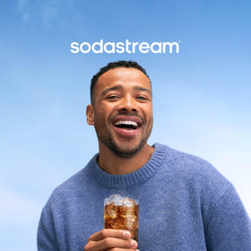 SodaStream MUG Root Beer product and glass with bubbles.