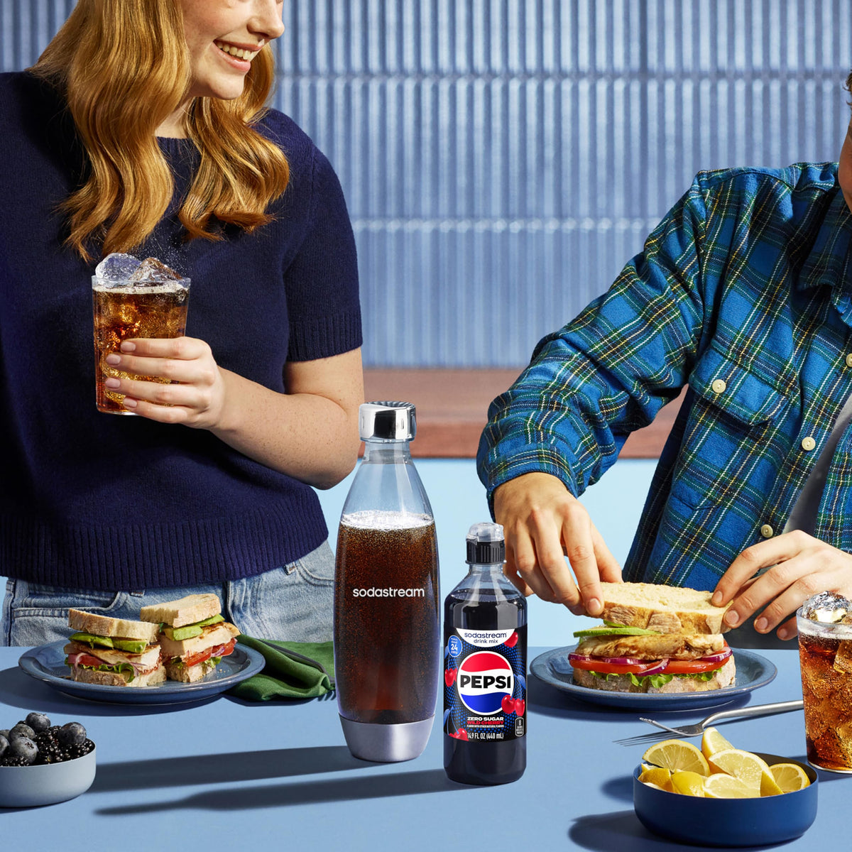 Friends enjoying SodaStream fizz at a casual gathering.