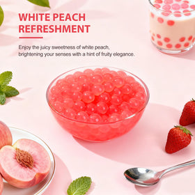 Soeos peach popping boba pearls being poured into a glass.