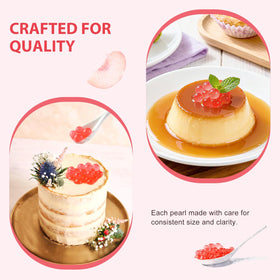 Soeos peach pearls atop vanilla ice cream for a fruity dessert.