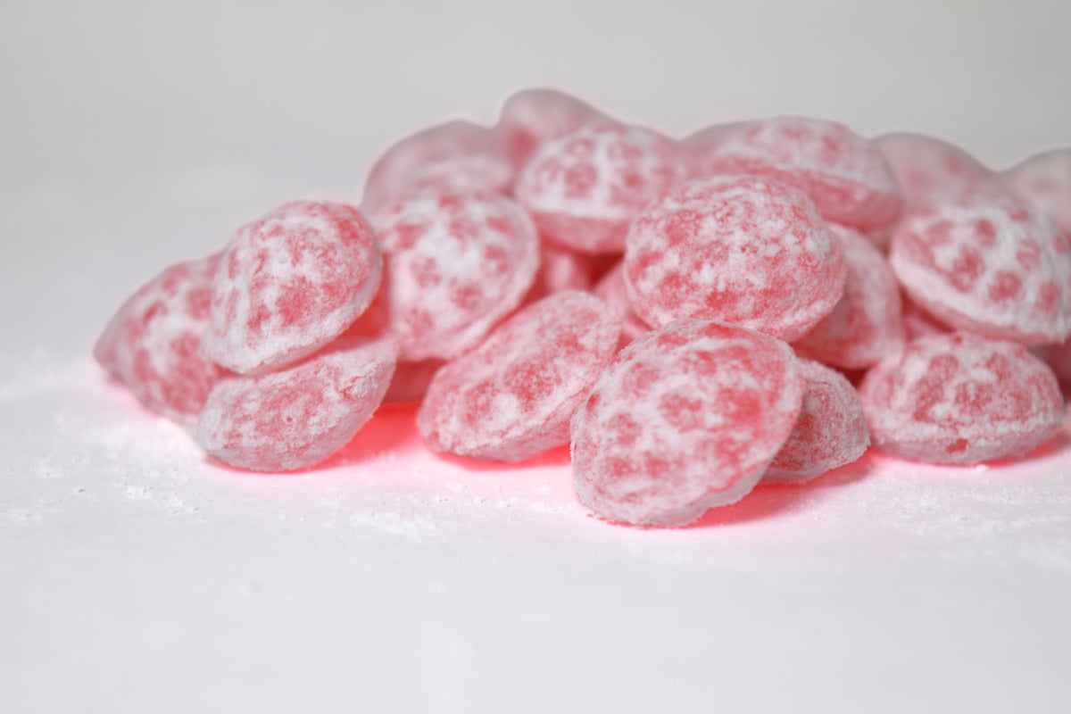 Vegan and gluten-free Sour Drops badge on tin signifies inclusive snack.