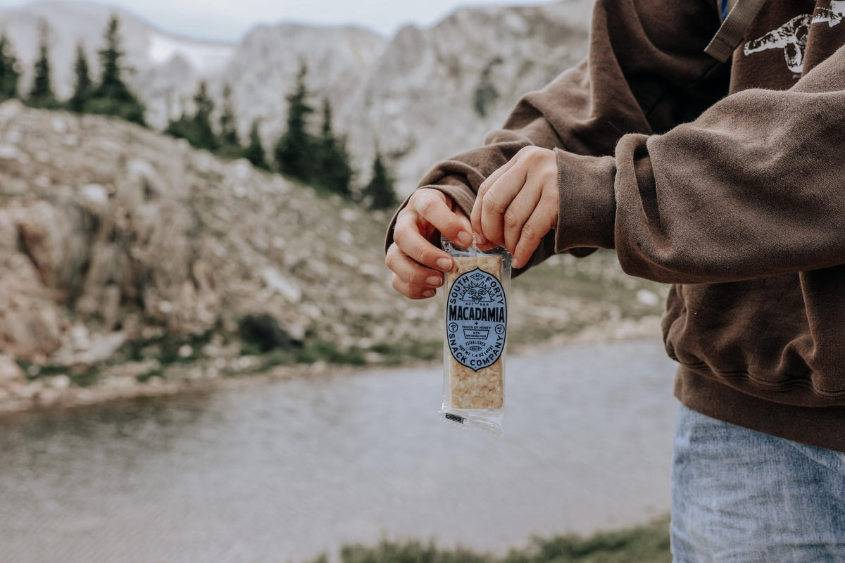 South Forty Snacks macadamia nut bar bite shows a crunchy, real ingredients snack option.