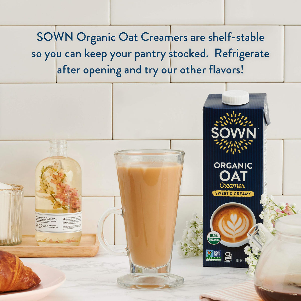 Stacked SOWN Oat Creamer bottles on pantry shelf, six-pack