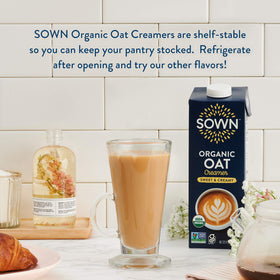 Stacked SOWN Oat Creamer bottles on pantry shelf, six-pack