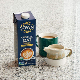 SOWN Oat Creamer with coffee cup, showcasing sweet and creamy flavor