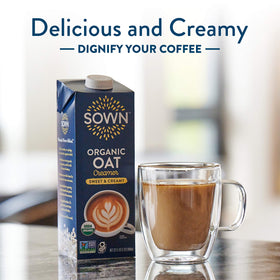 SOWN Organic Oat Creamer pouring into a mug with steam, highlighting creamy texture