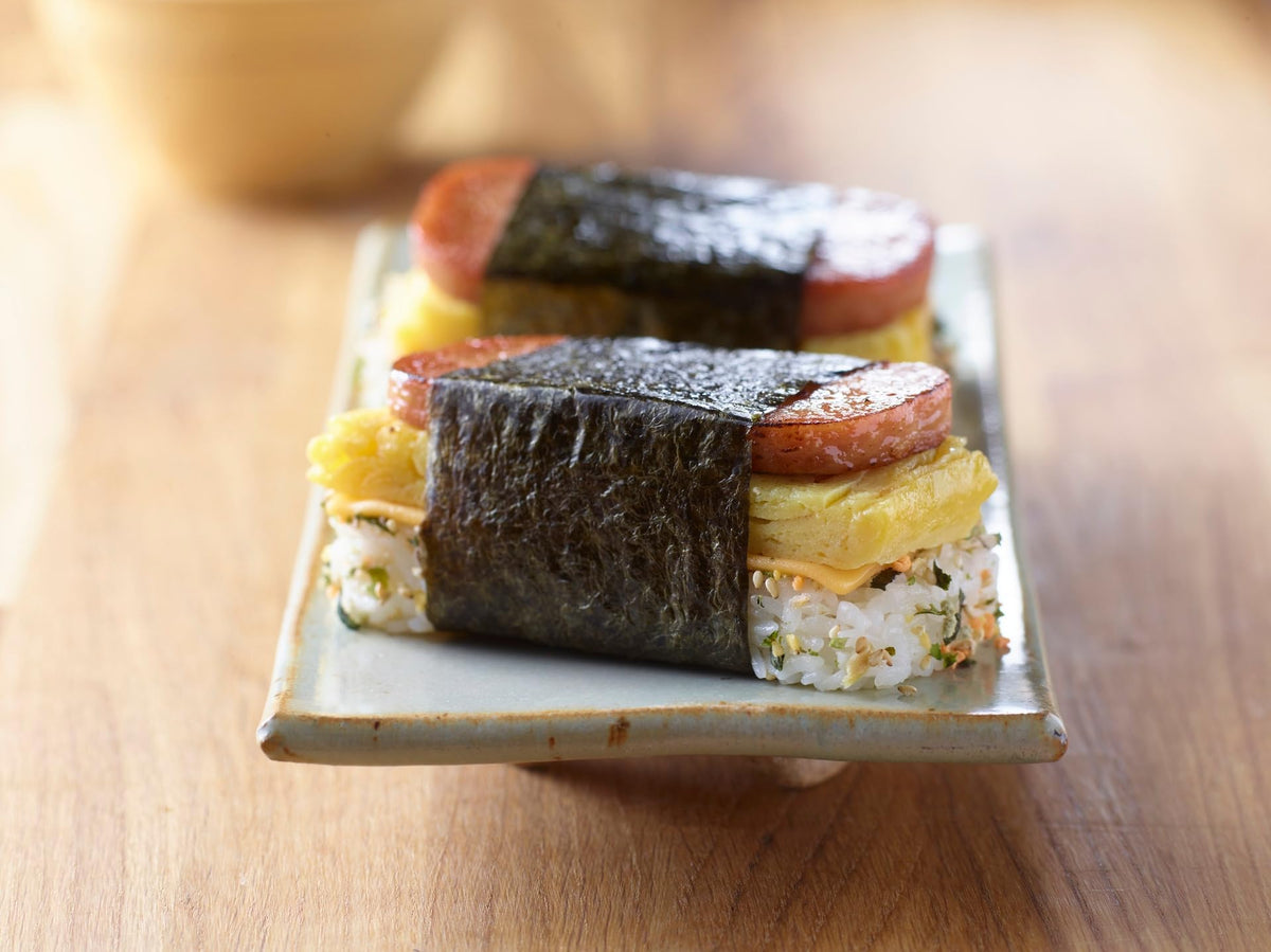 SPAM Classic sliced on cutting board for sandwiches or breakfast.