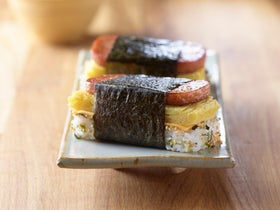 SPAM Classic sliced on cutting board for sandwiches or breakfast.