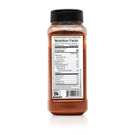 Grill scene with Spiceology Black Magic on food, showcasing smoky Cajun depth